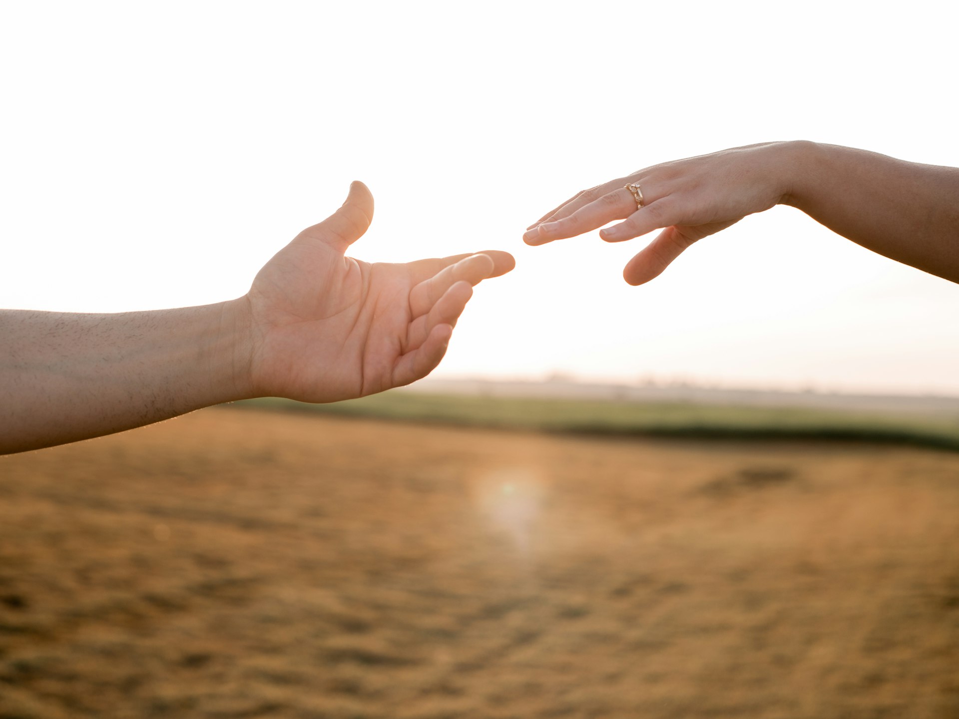 two hands reaching out towards each other
